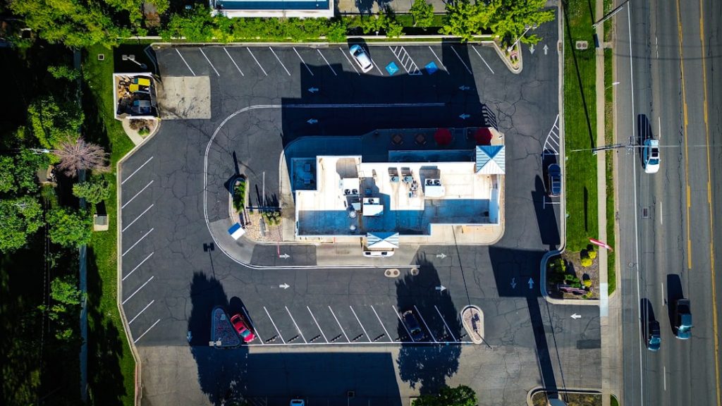 an-aerial-view-of-a-parking-lot-with-a-gas-station-6v1gbwk38qu